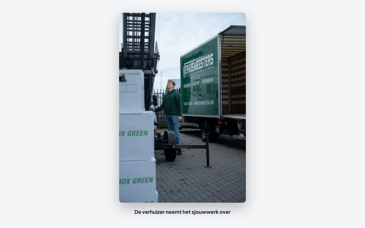 Verhuizer van VerhuisMeesters bij de verhuiswagen met een ingepakte verhuisdoos